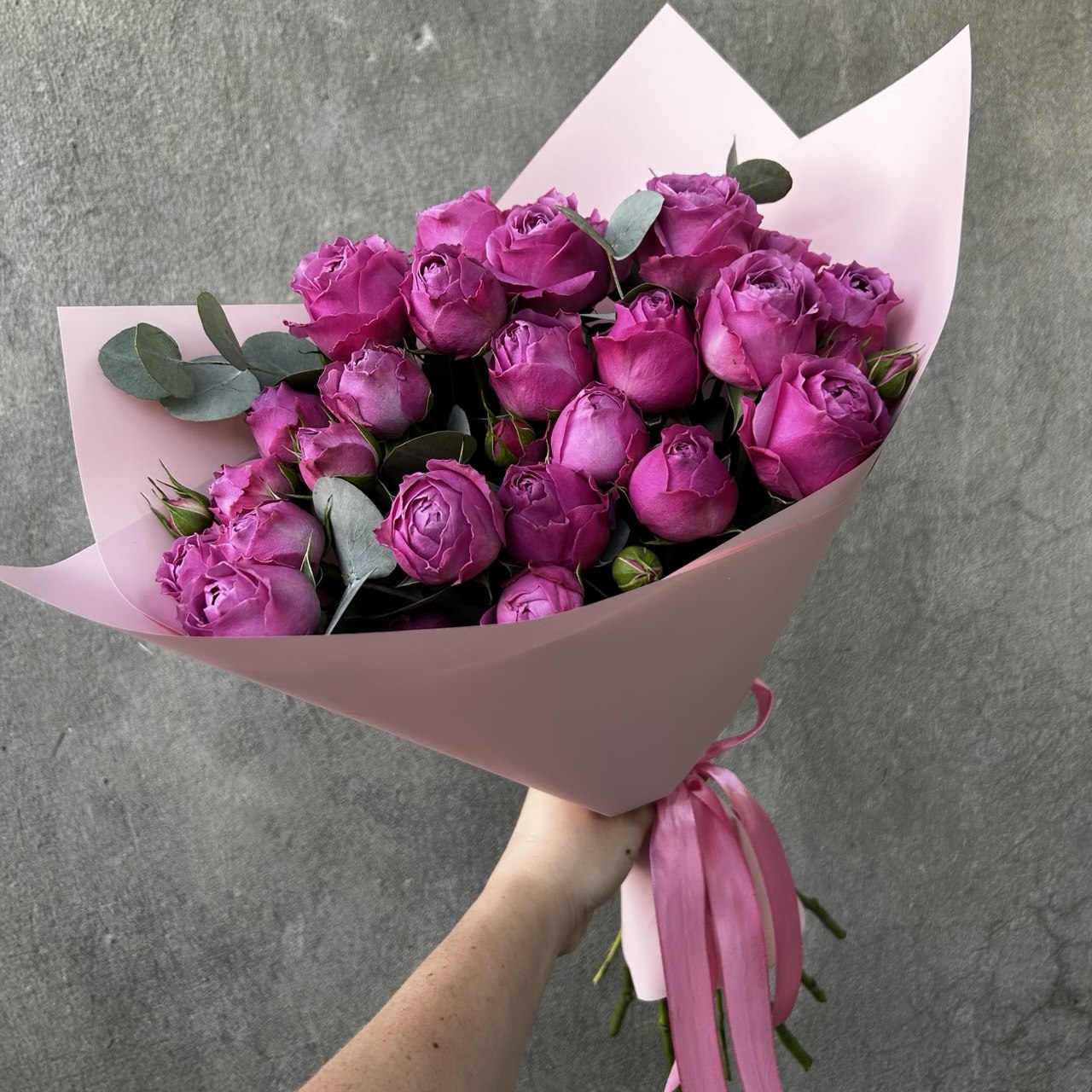 A bouquet of spray peony roses and eucalyptus