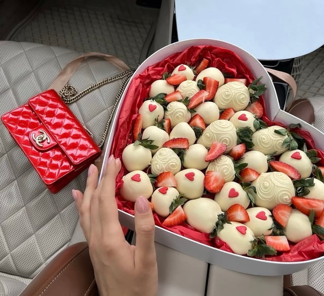 White chocolate-covered strawberries in a white heart-shaped box