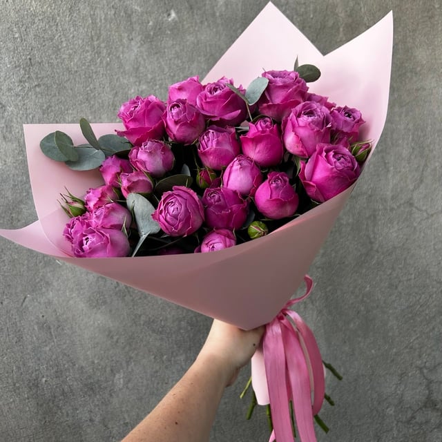 A bouquet of spray peony roses and eucalyptus