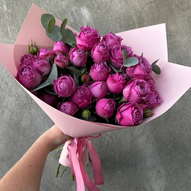 A bouquet of spray peony roses and eucalyptus